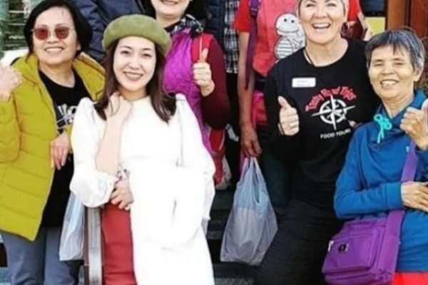 people smiling and posing for a photo outdoors