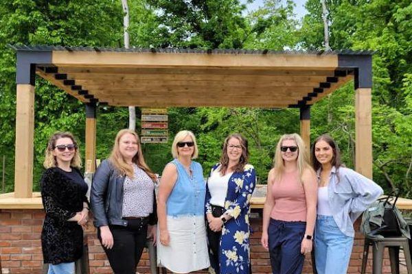 women posing for a picture outside in front of a bar